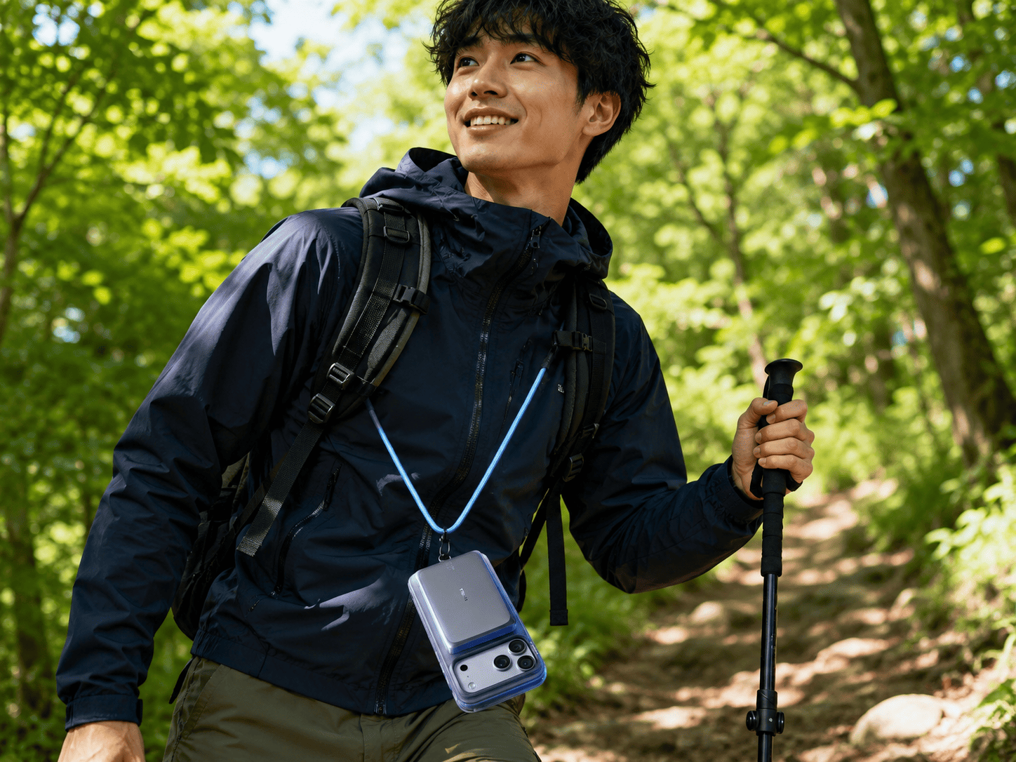 ハイキング中にTorrasのストラップ付きケースとモバイルバッテリーを愛用する男性。過酷なアウトドア環境でも、iPhoneの長時間駆動と安全な持ち運びをサポート