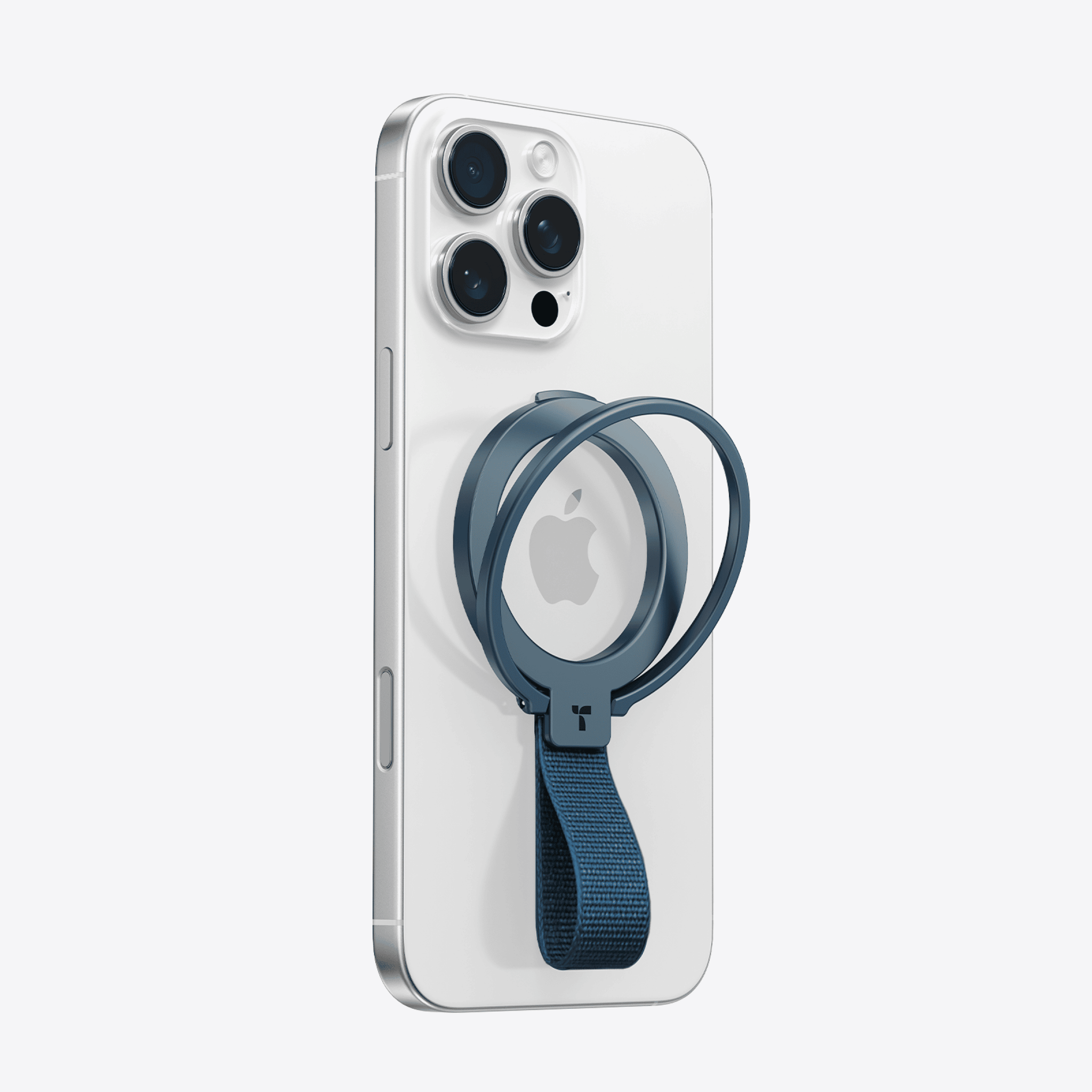 ダークブルーのOmniRingスマートフォンリングで、ファブリックストラップ付き、白色のiPhoneに磁気で取り付けられています。